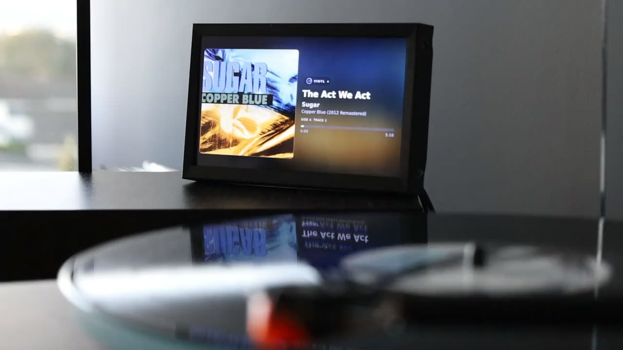 The Oceano display beside a turntable in a listening room